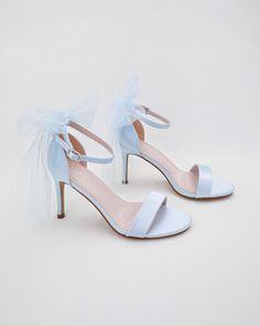 Classic satin high heel sandals adorned with tulle bow and ankle strap for romantic, elegant and feminine look. The light blue color can easily be your something blue. Simple and easy wear for bridal wear, bridesmaids, holiday party, wedding parties, and any special occasions. DETAILS: HEEL HEIGHT: 3.5 Inches Color Available: White, Ivory, Light Blue UPPER: Synthetic upper and lining MATERIALS: Manmade outsole ORIGIN: Imported STYLE NAME: DEMI Not sure of which size to purchase? Shoes measurements are as follow: (Please note measurements taken the length of inside of shoe from toe to heel). Size 6 - 9.25" Size 7 - 9.5" Size 8 - 9.75" Size 9 - 10" Size 10 - 10.25" Size 11 - 10.5" Please note all these info are intended for general reference and are to be used as a guide only. Age and size w Summer Wedding Tulle Heels, Spring Wedding Heels With Tulle Material, Ankle Strap Tulle Heels For Parties, Tulle Ankle Strap Heels For Party, Open Toe Tulle Heels For Party, Tulle Open Toe Heels For Party, Formal Tulle Open Toe Heels, Formal Tulle High Heels, Elegant Tulle Heels With Open Toe