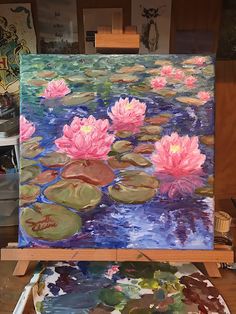 an easel with water lilies painted on it