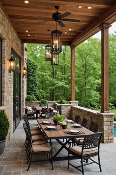 an outdoor dining area with table, chairs and ceiling fan in the middle of it