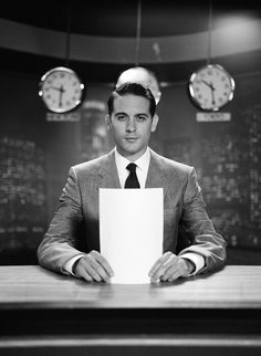 a man sitting at a desk holding a piece of paper