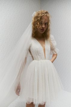 a woman wearing a white dress and veil