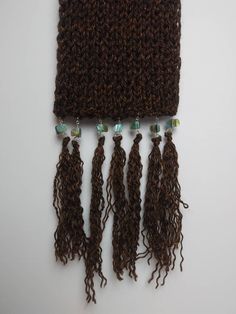 there are four pieces of crochet on top of each other with beads hanging from them