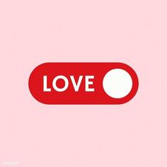 a red button with the word love written on it and a white dot in the center