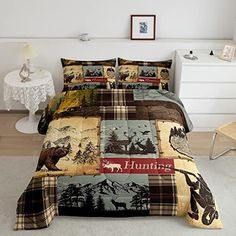 a bed covered in a plaid comforter with moose and trees on the coverlet