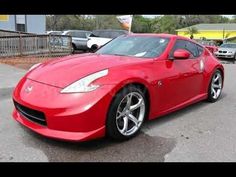 a red sports car parked in a parking lot