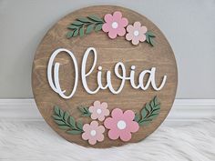 "PREVIEW YOUR FONT, COLOUR AND PAINT CHOICES AT:    www.whimsicalimaginings.ca Our custom cut 3D round wood floral name signs are a special and personalized way to complete your child's bedroom or nursery! They make wonderful gifts for baby showers and birthdays.  Each name sign is made to order, and will be personalized with the name of your choice. The sign base is laser cut from premium baltic birch, and the name is cut from 1/8\" premium acrylic.  The sign is finished in your preference of stain for the base, and acrlyic colours for the name. You may also choose the colour of your flowers, but the two-toned pink flowers are the default (shown are rose and blush). The back of the signs are unfinished (natural wood).  This design works best with only one name. If you would like two names Crib Name Sign, Nursery Name Sign With Flowers, Circle Baby Name Sign, Name Sign Above Crib, Flower Name Sign, Floral Name Sign Nursery, Daisy Name, Wooden Name Signs Nursery Flower, Name Paintings