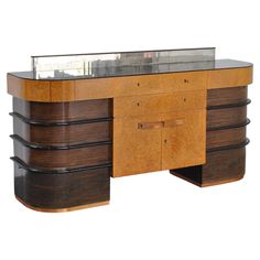 an art deco desk with glass top and drawers