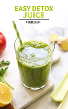 a green smoothie in a glass with a straw