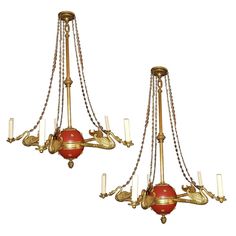 two red and gold chandeliers hanging from chains