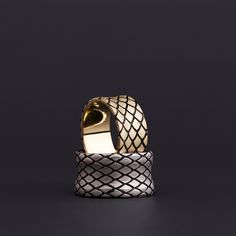 Discover a symphony of geometry and luster with our "Geometric Elegance" men's band. Expertly crafted with precision, this ring showcases a stunning two-tone design featuring a sterling silver base adorned with a diamond-shaped pattern, topped with a lavish gold finish. The contrasting textures and colors meld to create a visual spectacle, reflecting light in a dance of brilliance with each movement of the hand. This ring is a celebration of modern design infused with timeless elegance, perfect for the style-conscious individual. Make a statement with this distinctive piece, a blend of sophistication and bold style, available exclusively in our collection. Elegant Sterling Silver Wide Band Ring, Luxury Sterling Silver Bands, Luxury Bands For Anniversary, Elegant Diamond Cut Wide Band Ring For Gift, Elegant Diamond Cut Wide Band Ring As Gift, Elegant Wide Band Ring, Luxury Gold Band With Diamond Cut, Luxury White Gold Thick Band, Elegant Gold Open Ring Band