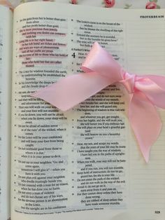 a pink ribbon on top of an open book