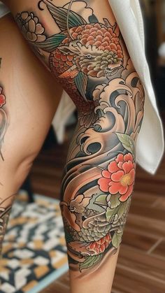 a woman's legs with tattoos and flowers on them