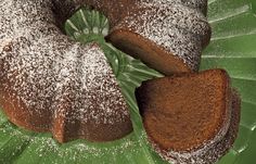 a bundt cake with powdered sugar on top and two slices cut out to show the inside