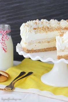 a piece of cake sitting on top of a white plate next to a jar of milk