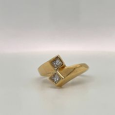 This ring is a simple Retro Design to symbolize Love & Friendship. Would make a great Engagement ring for the bride who does not prefer traditional single center stone ring. Details: Size: The ring is a Size 6. ( can be sized upon request) The stones are: 2 Princess cut Diamonds, Bezel set, G color VS2 clarity. .33ct total. Metal: 14K yellow gold The band tappers from 3.47 to 5.17mm. Every Antique piece of jewelry we sell at Heirloom Pavé has been checked for safety of each prong and repaire 14k Gold Princess Cut Ring With Tension Setting, Modern 14k Gold Bypass Ring For Anniversary, Modern Solitaire Birthstone Ring For Anniversary, Modern Diamond White Bypass Ring For Anniversary, Modern Bypass Ring With Prong Setting For Anniversary, Diamond Toe Ring For Anniversary, Heirloom Promise Ring With Tension Setting, Formal Couple Diamond Rings With Open Design, Formal Gold Solitaire Couple Rings