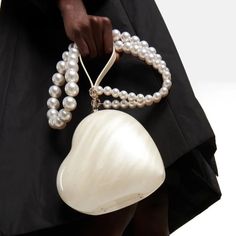 Introducing the Fiadh Heart Pearl Resin Clutch - a beautiful and luxurious addition to any outfit. This clutch is made of resin and features a gorgeous pearl heart detail. Its sleek design makes it perfect for weddings, galas, or a night out on the town or just be fashionista. Be sure to dress to impress with the Fiadh Heart Pearl Resin Clutch. SIZE" W10cm x H13cm / W3.9" x H5.1" Gender: WOMEN Item Type: Handbags & Shoulder Bag, Evening Clutch Main Material: Acrylic Plastic Resin, Imitation Pear Resin Clutch, Pearl Clutch Bag, Pearl Resin, Heart Shaped Bag, Pearl Clutch, Embellished Clutch, Pearl Heart, Pearl Bag, Sopot