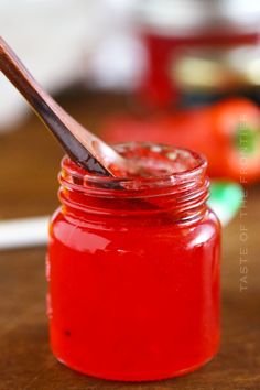 a wooden spoon is in a red jar