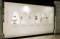 an art exhibit is displayed in front of a white wall with the words pabs on it