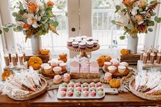 a table topped with lots of cupcakes and cakes