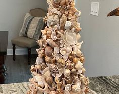 a christmas tree made out of seashells in a living room