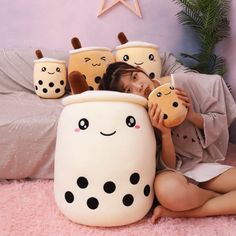 a woman is laying on the floor with her stuffed animals in front of her face