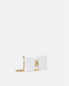 Versace Greca Goddess Mini Bag for Women | US Online Store Elegant White Shoulder Bag With Logo Hardware, Formal White Bags With Metal Logo, White Shoulder Bag With Metal Logo For Evening, Elegant White Bags With Metal Logo, White Evening Bag With Metal Logo, Elegant White Shoulder Bag With Metal Logo, Elegant Crossbody Bag With Logo Hardware, Evening Wallet On Chain With Metal Logo, Rectangular Evening Wallet On Chain With Metal Logo