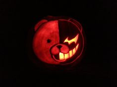 a bear carved into a pumpkin in the dark