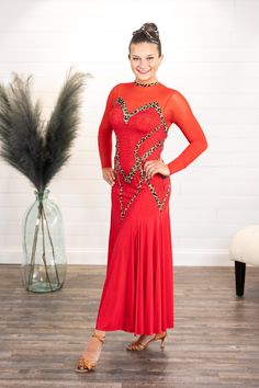 a woman in a red dress posing for the camera with her hands on her hips