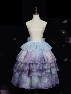 This exquisite piece features a mesmerizing oil painting print that captures the whimsical essence of fairycore aesthetics. The tiered ruffles add layers of elegance and movement, creating a dreamy silhouette that is both classic and contemporary. Designed with comfort in mind, the skirt boasts an elasticized back waistband, ensuring a snug yet flexible fit for all-day wear.   	 		 			Size 			S 			M 			L 		 		 			Waist 			62-75 			66-79 			70-83 		 		 			Full Length 			80 			81 			82 		 		 			He Purple Fairycore, Fairy Kei Tiered Ruffled Skirt, Purple Fairycore Dress With Ruffles, Harajuku Style Tiered Ruffled Mini Skirt, Pink Fairy Kei Tiered Skirt, Blue Fairy Kei Dress With Ruffles, The Thorn Birds, Flower Choker, Fashion Bottoms