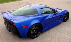 a blue sports car parked on the street