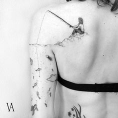 the back of a woman's body with tattoos on it