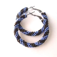 "A woven pair of Khaki and blue hoop earrings.  These earrings were weaved with glass seed beads forming a spiral effect. The beads were woven onto tarnish resistant stainless steel hoops. Finished weaved hoops measure:  1.625\" inches across the widest part of the earrings ( 4.1275 cm ) outside diameter, which is a little over 1 - 1/2\" inch across  ( 3.81 cm ) the outside diameter. https://www.etsy.com/shop/FMGuyDesigns" Handmade Blue Beaded Hoop Earrings, Blue Wire Wrapped Hoop Beaded Earrings, Blue Hoop Earrings, Green Tassel Earrings, White Hoop Earrings, Toms River Nj, Earrings Bead, Red Jewelry, Earrings Beaded