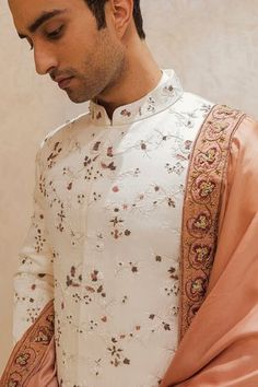 White linen silk sherwani featuring fine tone on tone embroidered floral motifs highlighted with zari work. Comes with kurta, pant and stole. Components: 4 Pattern: Embroidered Type Of Work: Zari Neckline: Mandarin Collar Sleeve Type: Full Fabric: Linen Silk Color: White Other Details:  Hidden placket Tone on tone embroidery Contrast stole Occasion: Groom,Wedding - Aza Fashions Manpreet Toor, Dhoti Pants, Mens Kurta Designs, Indian Man, Haldi Ceremony, Fashion Design Portfolio, Indian Wedding Outfits, Churidar, Fashion App