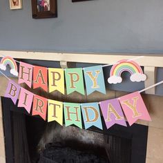 a happy birthday banner hanging over a fireplace