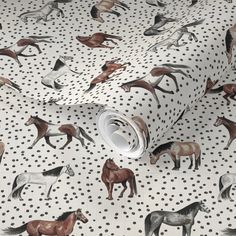 a white wallpaper with horses on it and polka dotty dots in the background