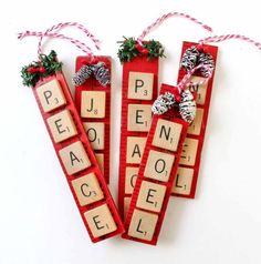 three wooden scrabbles with christmas decorations on them