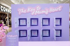 the key to your heart sign is displayed in front of a purple wall with pink flowers