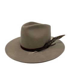 Tall crown in a stockman felt makes this fedora stiff to the touch with no movement. wrapped with suede and adorned with a feather she is a show stopper. It should fit high on your head . please size up if you are in between sizes . Made in the USA. exchange or site credit only sm 21-22 inch circ md 22-23 inch circ lg 23-24 inch circ Custom Fur Felt Fedora, Rodeo Fedora Felt Hat With Feather Trim, Western Fedora With Feathers And Flat Brim, Western Style Fedora With Feathers And Flat Brim, Felt Fedora With Feather Trim For Rodeo, Western Wide-brim Fedora With Feathers, Western Wide Brim Fedora With Feather Trim, Western Style Brimmed Fedora With Feathers, Winter Feathered Flat Brim Felt Hat