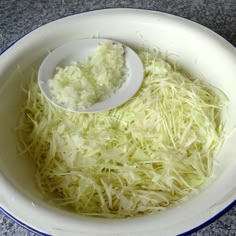 shredded cabbage in a bowl with a spoon