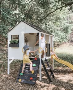 two children playing in a small white house