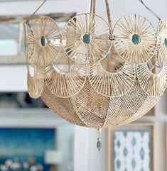 a chandelier made out of wicker hanging from the ceiling in a living room