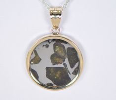 IMILAC PALLASITE METEORITE PENDANT - METEORITE JEWELRY - GOLD On Offer: Beautiful Imilac Pallasite Meteorite Pendant set in 14K Gold. Dimensions not including bail: Approximately 22.75mm x 3.40mm Dimensions including bail: Approximately 33.23mm x 6.34mm Includes an 18" gold chain. Value $450 The majestic Imilac meteorite is arguably one of the most beautiful pallasites ever discovered. The olivine crystals in these pallasite meteorites are among the most prized gemstones in the world. This piece Yellow Gold Jewelry With Natural Inclusions For Anniversary, Fine Jewelry In Yellow Gold With Natural Inclusions, Anniversary Pendant Jewelry With Natural Inclusions, Meteorite Jewelry, Meteorite Pendant, Gold Top, Pendant Set, The Space, Gold Chain