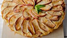 an apple pie with slices cut out on a cutting board