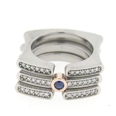 a stack of silver rings with diamonds on top and bottom, set in 18k white gold