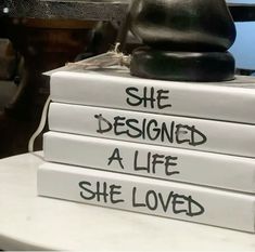 three books stacked on top of each other with the words she designed a life she loved