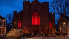 an old church lit up with red lights