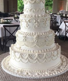 a large white wedding cake sitting on top of a table