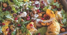 a salad with broccoli, cauliflower, nuts and cranberries