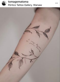 a tattoo on the arm of a woman with leaves and words written in cursive writing