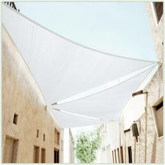 an alley way with white fabric covering the walkway